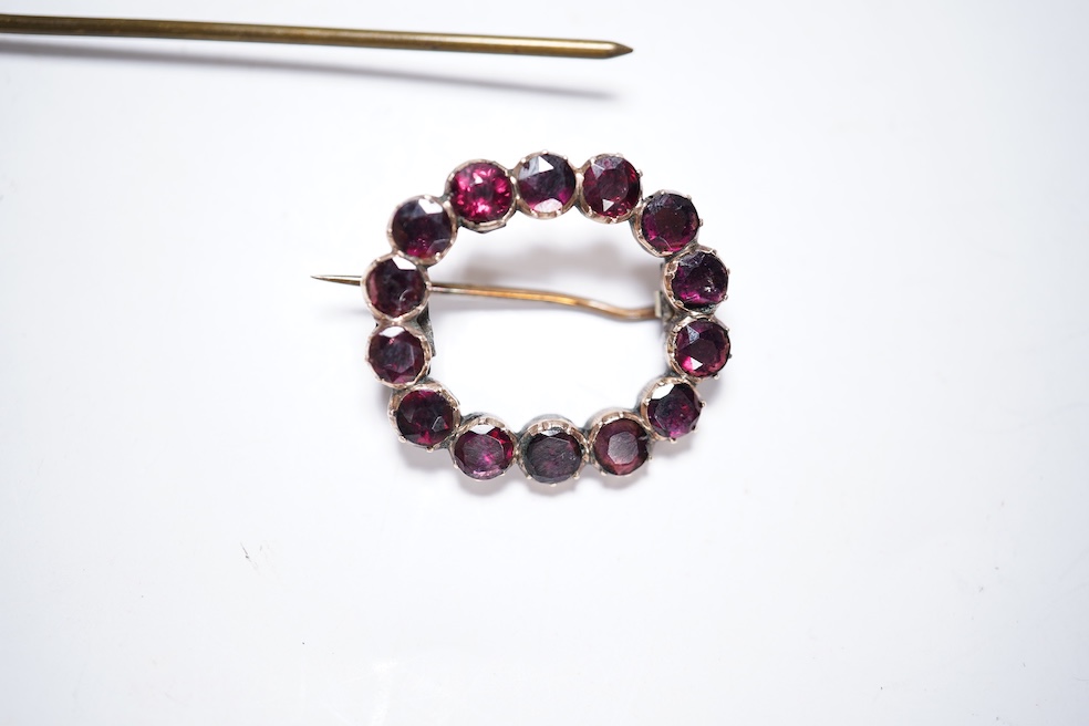 A Victorian yellow metal and garnet cluster set open work brooch, 27mm, together with two garnet cluster set hair ornaments. Condition - poor to fair
